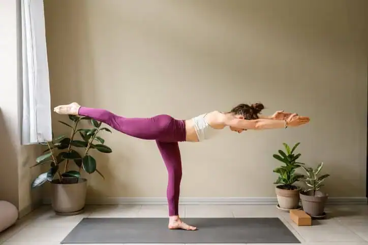 Woman doing Yoga exercise Hassocks to help with toning the body. 
